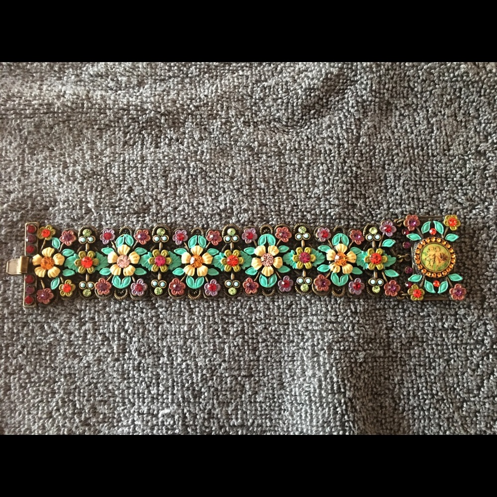 Multi-colored flower bracelet with cherub stone